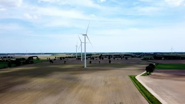 Renewable energy being generated by wind turbines on farmland creating sustainable electricity