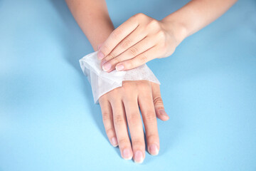 woman cleaning hands in napkin