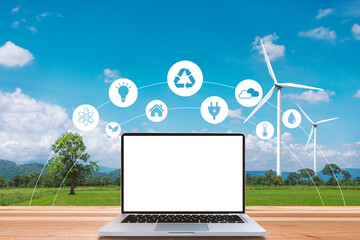 Technology and renewable energy, a laptop on a wooden table in a farm with wind turbines. For agriculture and improving the quality of life. and sustainable energy graphic icon.