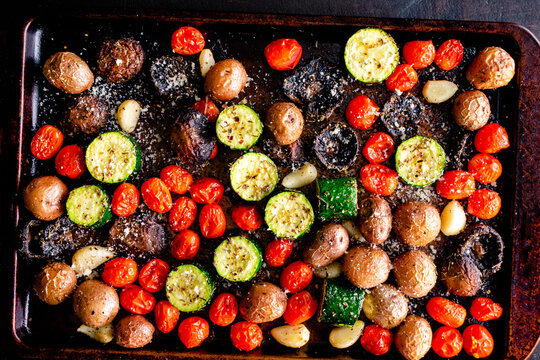 Italian Oven Roasted Vegetables On A Sheet Pan: Roasted Grape Tomatoes, Zucchini, Mushrooms, Red Potatoes, Garlic Cloves