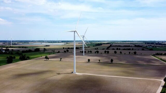 Renewable energy being generated by wind turbines on farmland creating sustainable electricity