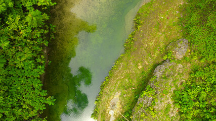 Aerial view of Stones in the river under a stream of water. Water flows over stones in a river.