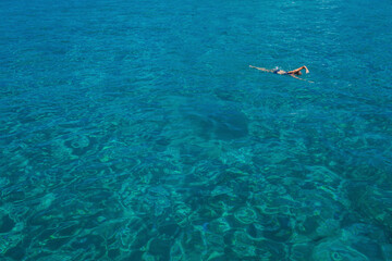 Aerial view of swimming beautiful woman in Blue Lagoon. Cyprus