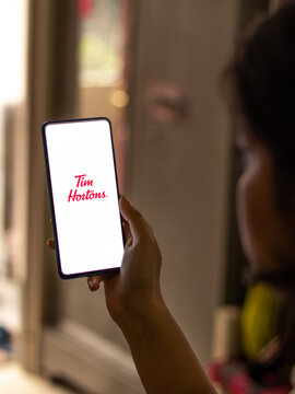 Assam, india - May 18, 2021 : Tim Hortons logo on phone screen stock image.