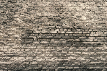 Fototapeta na wymiar Background and texture of old rough gray brick wall 