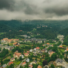 Fototapeta na wymiar Aerial drone view, small typical polish villagesurrounded by beautiful mountains at summer.