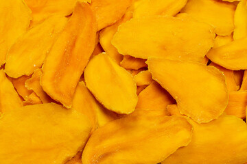 Dry sugar mango slices as a background.