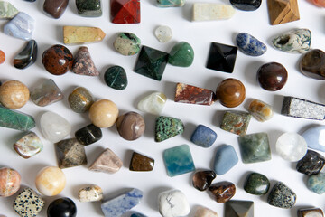 Large collection of beautiful stones. polished gems on a white background. Geologist exposition.