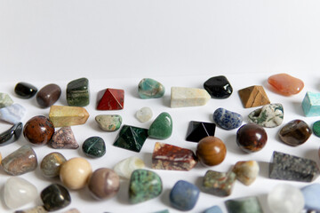 Large collection of beautiful stones. polished gems on a white background. Geologist exposition.