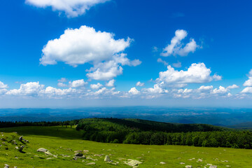 Landscape with top view, panoramic view of the Semenic mountains over the mountainous Banat region, Romania; relaxing mountain landscape with clouds and blue sky