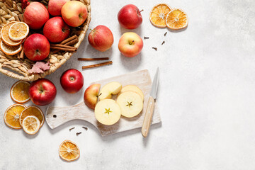 Fresh ripe red apples with knife and chopping board on white table background. Autumn apple flat lay, top view, copy space. Autumn harvest and cooking apple meal, apple pie concept.