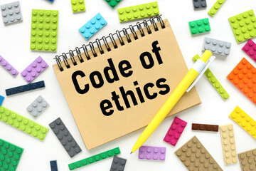 "Code of ethics, text on a craft notebook near the constructor of different colors