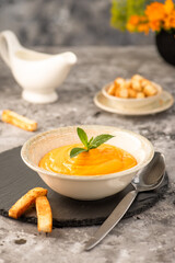 Creamy pumpkin and carrot soup, drizzled with cream. Served with fried croutons.