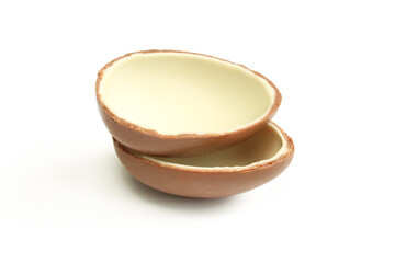 Two halves of milk chocolate egg isolated on white background. 