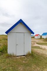Gouville-sur-Mer, Normandy, colorful wooden beach cabins in the dunes
