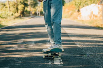 feet on skateboard skating on the road