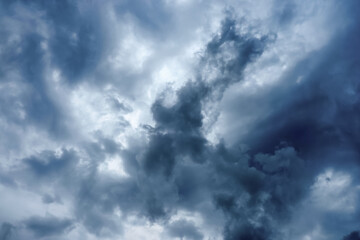 Naklejka na ściany i meble Dark storm clouds across the sky right before a rain shower, weather background