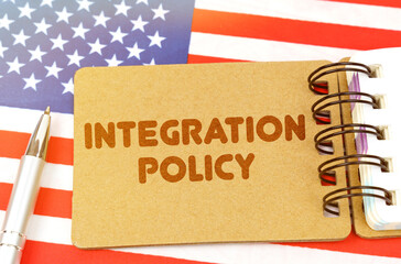 On the US flag lies a notebook with the inscription - Integration policy
