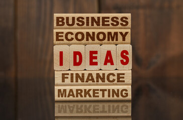 Wooden blocks with the text - Business, Economy, Finance, Marketing and IDEAS