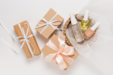 Organic cosmetics and gifts for the holiday. Flat lay, top view clear glass pump bottle, brush jar, moisturizing serum jar in a paper basket on a white background. Natural cosmetics SPA