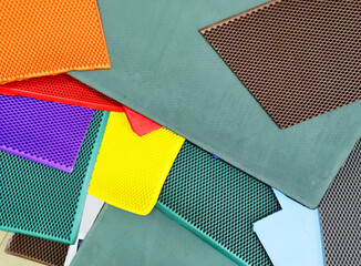 Abstract background made of multi-colored rubber pieces with a pattern of cells.