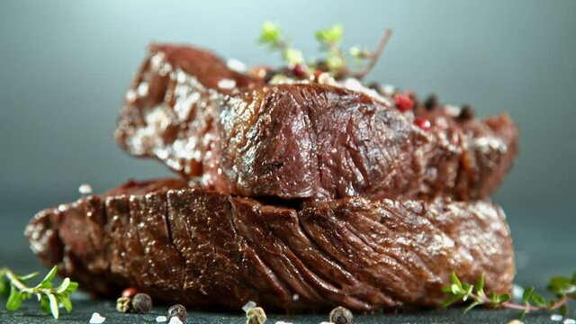 Close-up of falling tasty beef steak, super slow motion, filmed on high speed cinematic camera at 1000 fps.