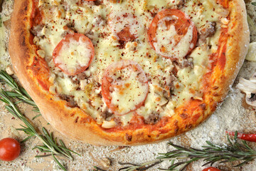 meat pizza with cheese tomato and mushrooms on wooden table with ingredients background.top view