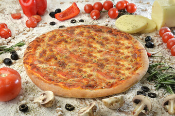 pizza with mushrooms tomato and cheese. served on wooden table with ingredients.