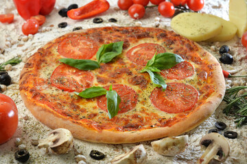 pizza with mushrooms tomato and cheese. served on wooden table with ingredients.
