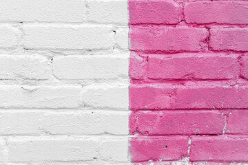 Pink and white brick wall detail texture background. Old, painted, weathered and cracked bricks with concrete and stucco. Stripes on house wall. Close up, copy space