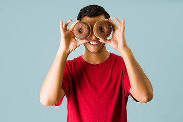 Fun latin man ready to eat donuts