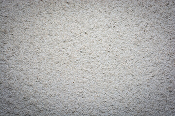 Concrete wall background covered with white rough cement mortar.