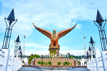 A sculpture of a red eagle spreading its wings. Popular tourist spot on Langkawi island - obrazy, fototapety, plakaty