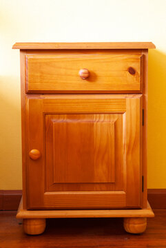 Vertical shot of a modern comfortable wooden bedside table