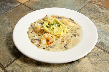Linguini marsala with shrimp pasta in white bowl