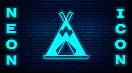 Glowing neon Traditional indian teepee or wigwam icon isolated on brick wall background. Indian tent. Vector © Kostiantyn