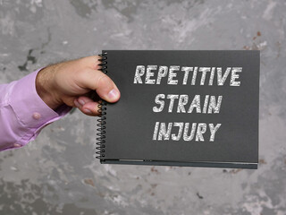 Business concept meaning REPETITIVE STRAIN INJURY with inscription on the piece of paper.