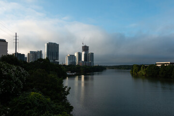 Naklejka premium Downtown Austin Texas Views of LadyBird Lake on A Sunny Day with White Clouds 