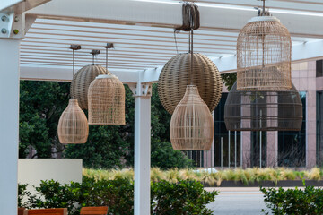 Outdoor Patio with Multiple Woven Light Fixtures or Lanterns and Shapes  - obrazy, fototapety, plakaty