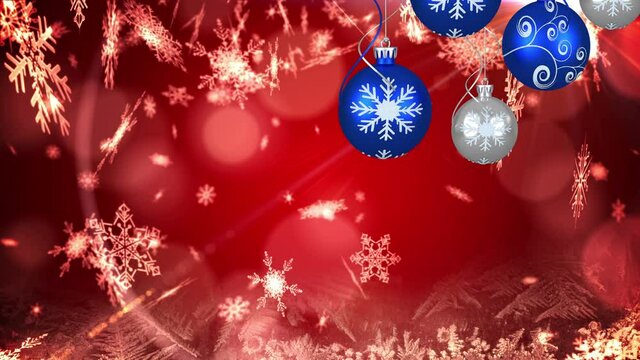 Animation of christmas boubles and snow falling over red background