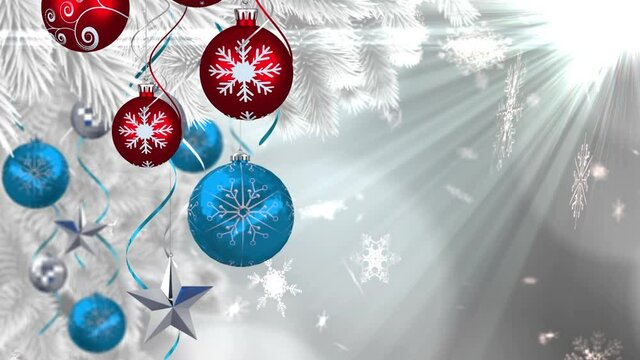 Animation of christmas boubles and snow falling over glowing light
