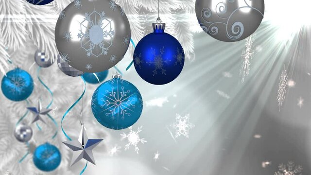 Animation of christmas boubles and snow falling over glowing light
