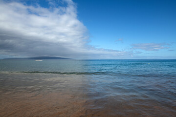 Summer vacation at a tropical beach. Paradise beach with sand and clear water of the sea. Ocean beach background.