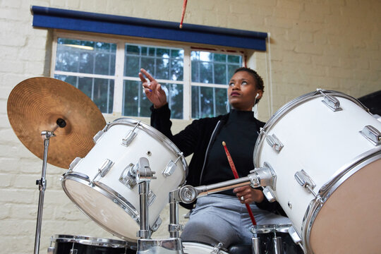 Black Woman With Short Hair Playing Drums