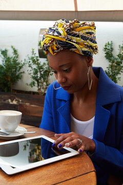 Black woman working from a coffee shop