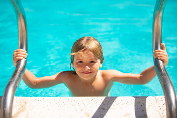 Cute child boy swim in swimming pool, summer water background with copy space. Funny kids face. Summer activities for happy child on the pool.