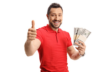 Happy young man in a red t-shirt holding money and showing thumbs up