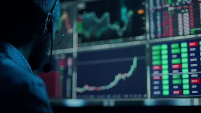 Trader is working with multiple computer screens with charts and data analysis and stock broker trading online. Concept of bitcoin and ethereum blockchain trading. Businessman is checking market data