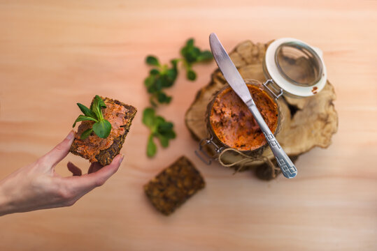 Hand Of A Woman Holding Wholemeal Bread With Liver And Pepper Pate. 