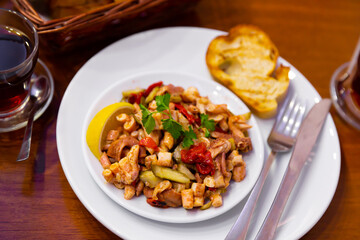 Ahtapot salatasi, traditional turkish octopus salad with vegetables and lemon